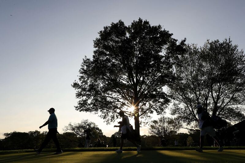 Patrick Reed walks off the ninth tee. AFP