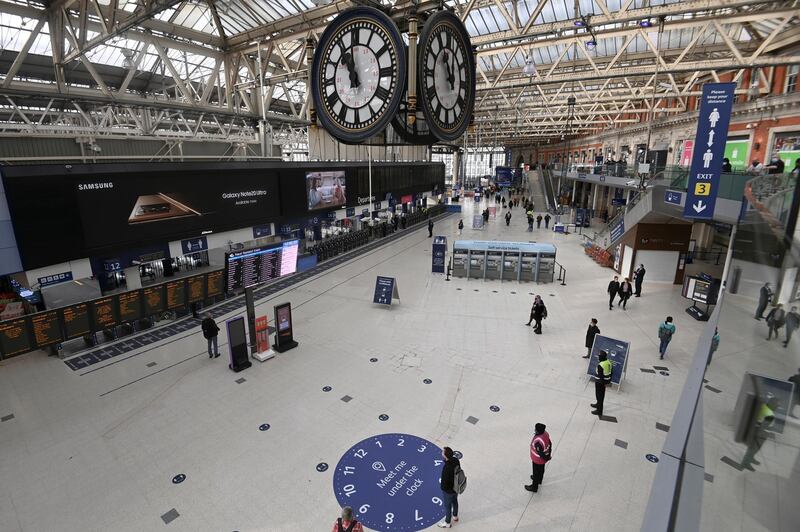 People pause to observe two minute's silence at Waterloo Station in London. Reuters