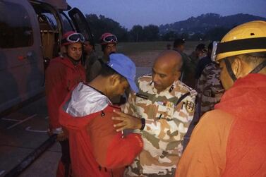 A Indo-Tibetan Border Police senior officer wishes luck to the team of soldiers before they leave to rescue and retrieve the bodies of international climbers. AP