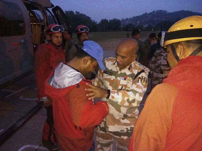 In this photo provided by the Indo Tibetan Border Police force or ITBP, a senior officer ITBP wishes best luck to the team of their soldiers before they set to leave to rescue and retrieve the bodies of international climbers, in Pithoragarh, Uttarakhand state, India, Wednesday, June 5, 2019. Indian officials are working on a plan to retrieve five bodies believed to be mountaineers from a team of international climbers that went missing on a notoriously dangerous Himalayan mountain. Local officials say all eight of the climbers that disappeared May 26 on Nanda Devi East are presumed dead, and the five bodies photographed by air Monday are thought to be from the missing expedition. The missing team includes four Britons, two Americans, an Australian and an Indian liaison officer. (Indo Tibetan Border Police force via AP)