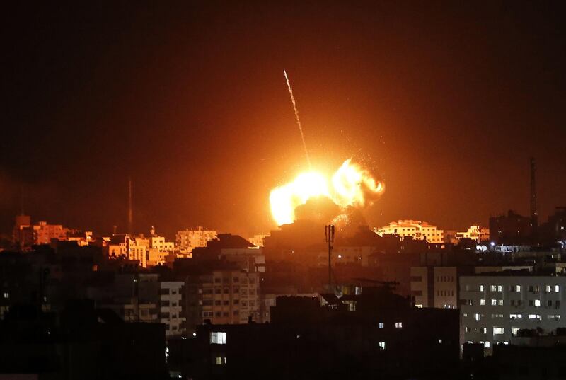 A ball of fire lights the sky above a building in Gaza City. AFP