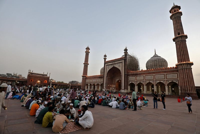 People eat their Iftar (breaking fast) meals on the first day of the Muslim fasting month of Ramadan at Jama Masjid in the old quarters of Delhi, India, May 7, 2019. Picture taken May 7, 2019. REUTERS/Anushree Fadnavis