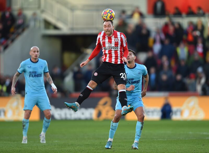 Brentford's Christian Eriksen, centre, in action against Newcastle's Bruno Guimaraes. EPA