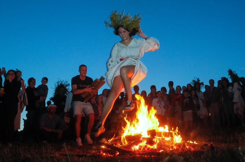 A Ukrainian woman jumps over a bonfire in Kiev, as they celebrate the traditional pagan holiday of Ivana Kupala. EPA