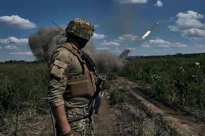 A Ukrainian soldier watches a Grad multiple launch rocket system firing shells near Bakhmut. AP