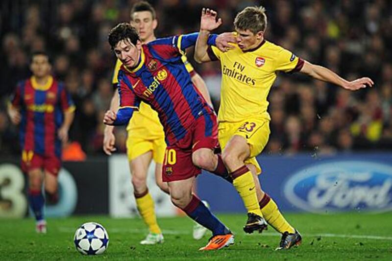 Lionel Messi, left, takes on Andrey Arshavin during Barcelona's 3-1 win at Camp Nou.