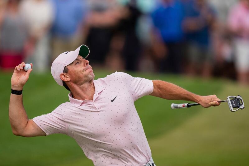 Rory McIlroy throws his ball to the crowd after winning on the 18th hole during the fourth round of the Wells Fargo Championship golf tournament at Quail Hollow on Sunday, May 9, 2021, in Charlotte, N.C. (AP Photo/Jacob Kupferman)
