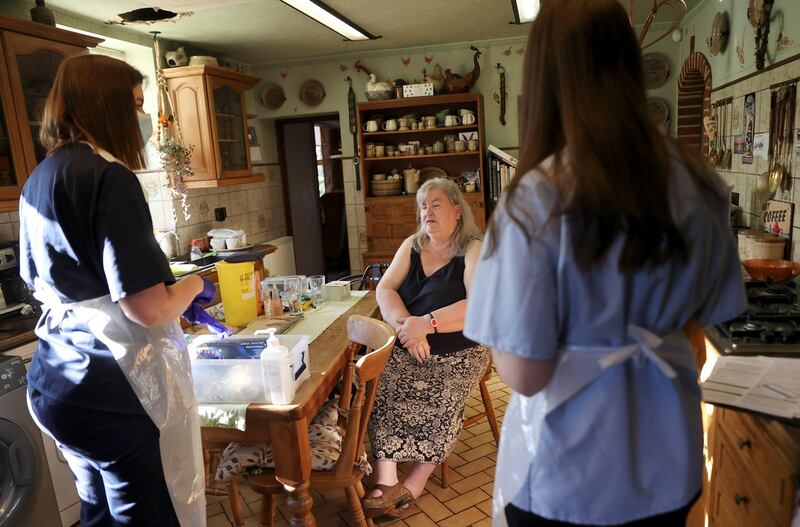 Nurses Elspeth Huber and Rebecca Lock from Hannage Brook Medical Centre talk to the patient before administering the vaccine during home visits in Derbyshire. Reuters