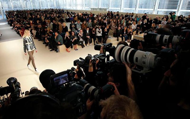 Photographers and television crews work as a model presents a creation by French designer Nicolas Ghesquiere for fashion house Louis Vuitton as part of his Fall/Winter 2014-2015 women's ready-to-wear collection show during Paris Fashion Week March 5, 2014. REUTERS/Stephane Mahe (FRANCE - Tags: FASHION MEDIA)