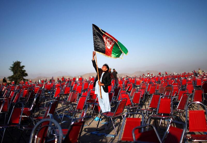 A supporter of Afghan presidential candidate Abdullah Abdullah holds an Afghan flag after an election campaign rally in the Paghman district of Kabul, in this June 9 file photo. Ahmad Masood / Reuters