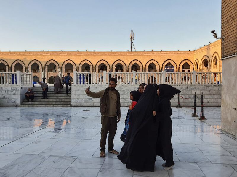 A family taking a selfie inside the mausoleum of Sheikh Abdul Qader Gailani in Baghdad, Iraq. Sinan Mahmoud / The National