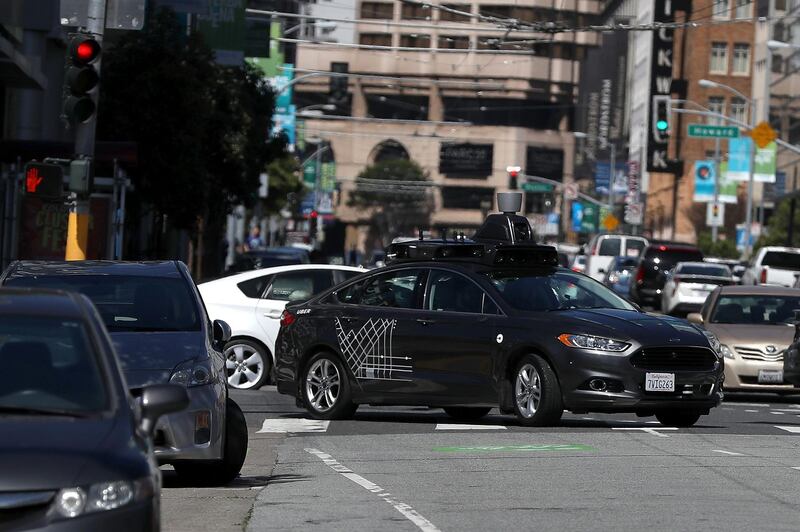 (FILES) In this file photo taken on March 27, 2017 an Uber self-driving car drives down 5th Street on March 28, 2017 in San Francisco, California. 
The race to perfect robot cars continues despite fears kindled by the death of a woman hit by a self-driving Uber vehicle while pushing a bicycle across an Arizona street. Uber put a temporary halt to its self-driving car program in the US after the fatal accident this month near Phoenix, where several other companies including Google-owned Waymo are testing such technology.
 / AFP PHOTO / Getty Images North America / JUSTIN SULLIVAN / 
With AFP Story by Ian TIMBERLAKE:  US-lifestyle-internet-automobile-Uber,foucs

