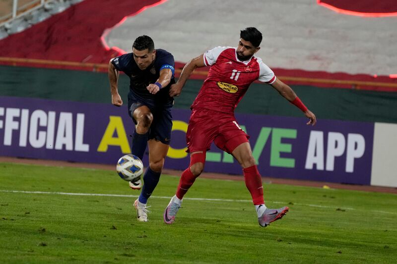 Al Nassr's Cristiano Ronaldo fights for the ball with Danial Esmaeilifar of Persepolis. AP 