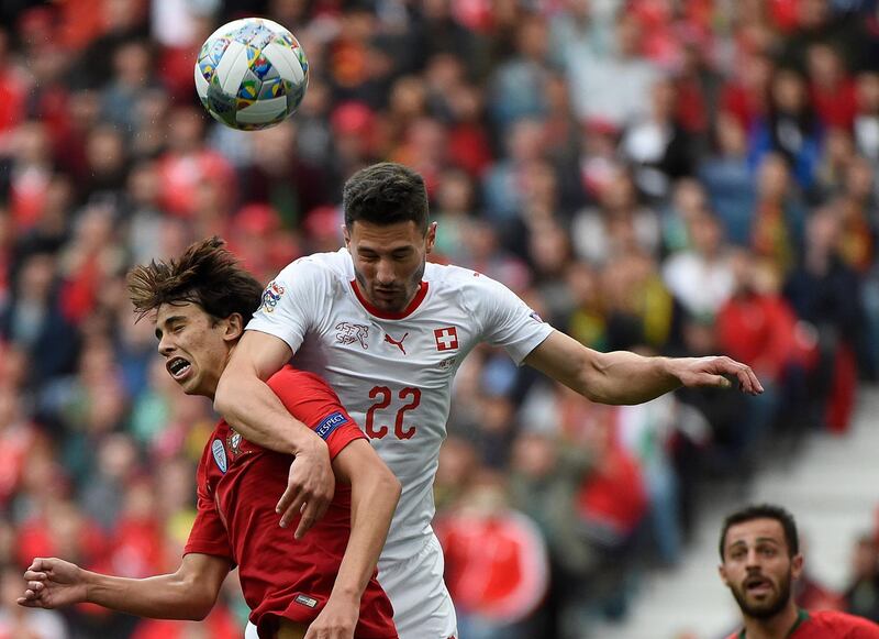 Switzerland's defender Fabian Schar (R) heads the ball with Portugal's midfielder Joao Felix during the UEFA Nations League semi-final. AFP