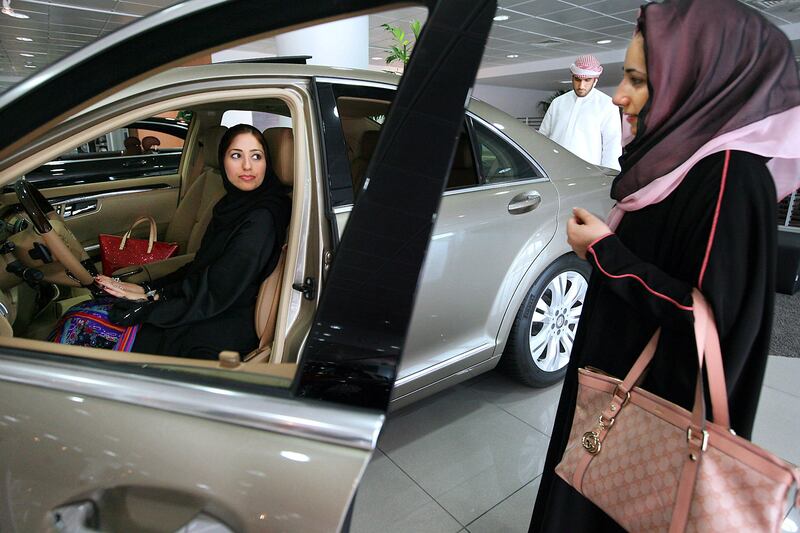 Abu Dhabi, United Arab Emirates - August 2, 2009  Maryam al Suweidi (right) and her sister-in-law, Hind al Thehli, look over a car in the Emirates Motor Company's Mercedes-Benz showroom near Marina Mall in Abu Dhabi on Sunday, August 2, 2009.  ( Delores Johnson / The National )