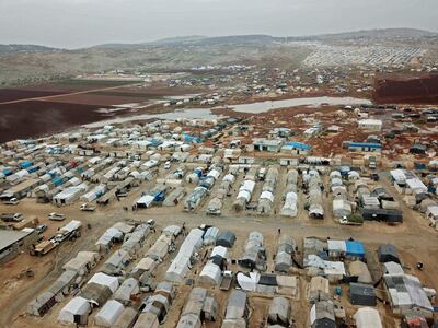 TOPSHOT - A drone picture taken on December 15, 2020 shows a camp for displaced Syrians near the town of Kafr Lusin by the border with Turkey, in Syria's rebel-held northwestern province of Idlib.  / AFP / Aaref WATAD
