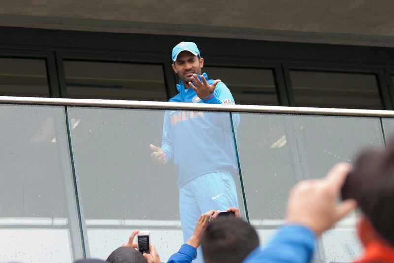 India's Dinesh Karthik checks the rainfall at Edgbaston cricket ground before his team's ICC Champions Trophy Final cricket match against England, Birmingham, England, Sunday June 23, 2013. (AP Photo/Jon Super) *** Local Caption ***  Britain ICC Trophy Final England India Cricket .JPEG-0b0e1.jpg