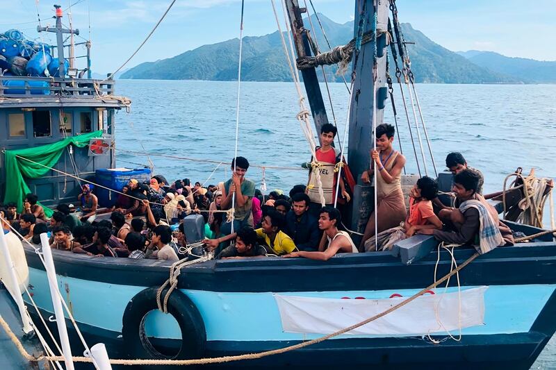 FILE - In this undated file photo released on April 5, 2020, by the Malaysian Maritime Enforcement Agency, a wooden boat carries suspected Rohingya migrants detained in Malaysian territorial waters off the island of Langkawi, Malaysia. Malaysian authorities said Sunday, July 26, 2020 that they were searching for two dozen Rohingya refugees who are feared to have drowned after jumping off their boat off the northern resort island of Langkawi. (Malaysian Maritime Enforcement Agency via AP, File)