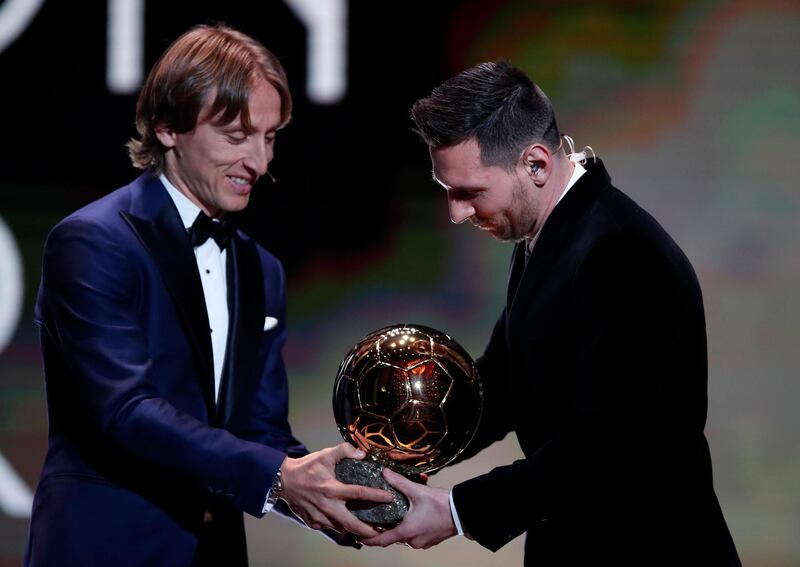 Barcelona's Lionel Messi, right, receives his sixth golden ball from Real Madrid's Lucas Modric during the Golden Ball award ceremony in Paris, Monday, December 2, 2019. AP Photo/Francois Mori