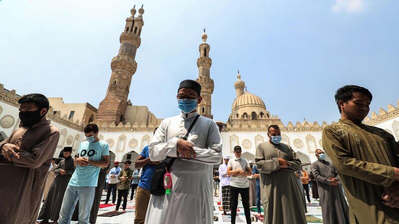 Muslim worshippers pray in the courtyard of the historic Al Azhar mosque in Cairo on August 28, 2020 as Egypt reopened mosques for Friday prayers. AFP