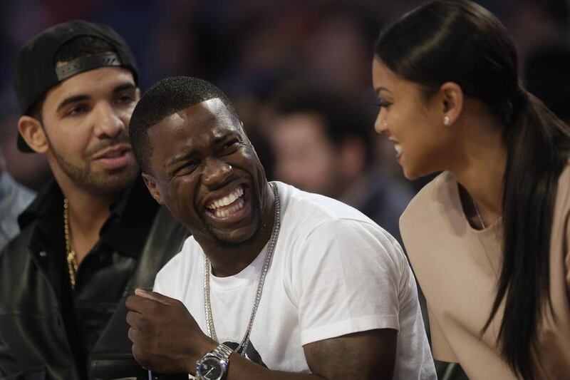 Actor Kevin Hart, centre, laughs as rapper Drake, left, looks on during the NBA All Star basketball game. Gerald Herbert / AP photo