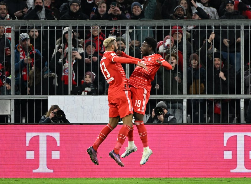Eric Maxim Choupo-Moting, left, celebrates scoring Bayern's first goal with Alphonso Davies. Reuters