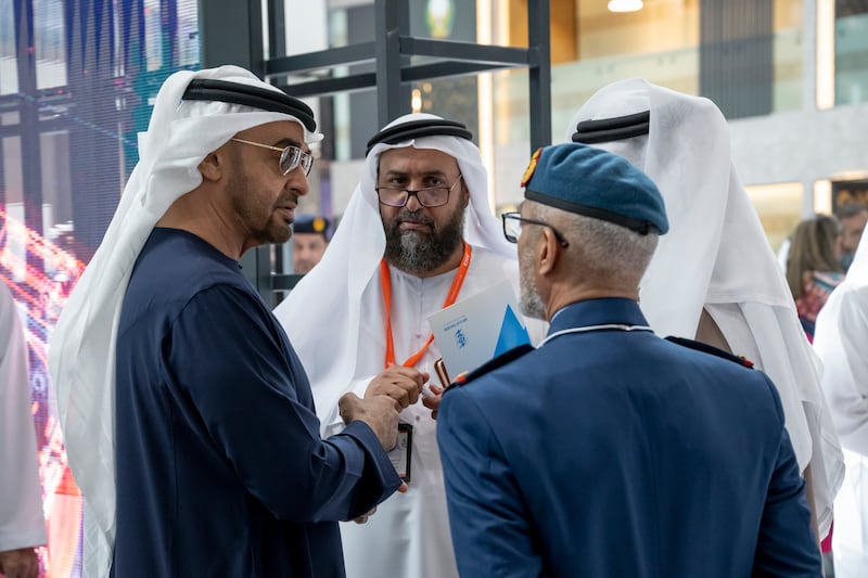 Sheikh Mohamed talks to Lt Gen Issa Al Mazrouei, Chief of Staff of the UAE Armed Forces, and other officials at Idex