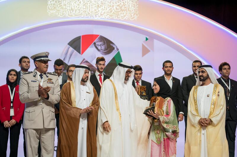 ABU DHABI, UNITED ARAB EMIRATES - November 22, 2017: HH Sheikh Mohamed bin Zayed Al Nahyan, Crown Prince of Abu Dhabi and Deputy Supreme Commander of the UAE Armed Forces (2nd R) and HH Sheikh Mohamed bin Rashid Al Maktoum, Vice-President, Prime Minister of the UAE, Ruler of Dubai and Minister of Defence (R), present an award to a winner, during the HH Sheikha Fatima bint Mubarak Awards for Excellence and Social Creativity, at Emirates Palace. Seen with HE Ali bin Salem Al Kaabi, Director of the Office of the Minister of Presidential Affairs, and Chairman of the Board of Trustees of the Family Development Foundation (2nd L) and HE Major General Mohamed Khalfan Al Romaithi ,Commander in Chief of Abu Dhabi Police and Abu Dhabi Executive Council Member (L).

( Mohamed Al Hammadi / Crown Prince Court - Abu Dhabi )
---