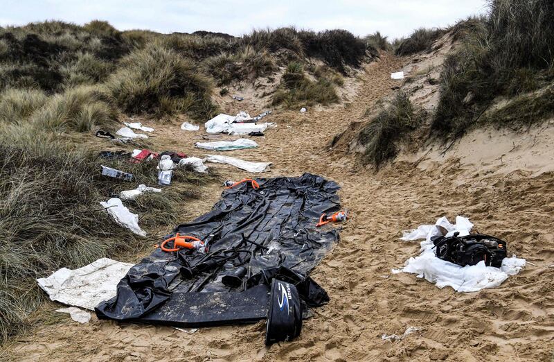 An inflatable boat, life vests and other remains left on a sand dune of the Wimereux beach, northern France. AFP