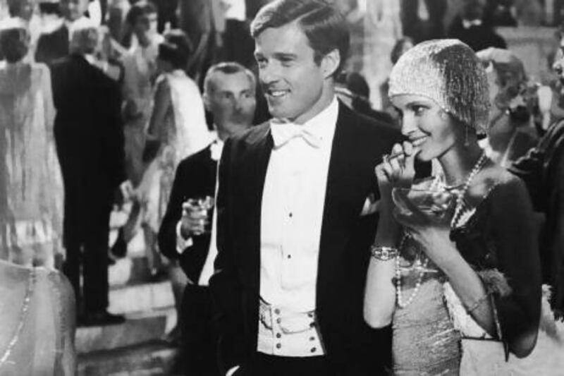 American actors Robert Redford, left, as Jay Gatsby, and Mia Farrow as Daisy Buchanan in a scene from The Great Gatsby, a 1974 film based on the novel by F Scott Fitzgerald. Paramount Pictures / Courtesy of Getty Images