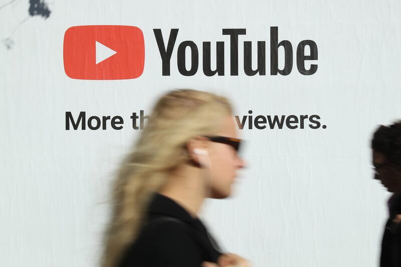 BERLIN, GERMANY - OCTOBER 5: A young woman walks past a billboard advertisement for YouTube on October 5, 2018 in Berlin, Germany. YouTube has established itself as the biggest global platform for online video presentations.  (Photo by Sean Gallup/Getty Images)