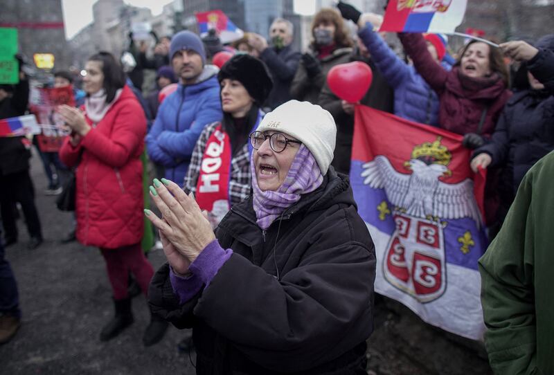 Supporters of Serbian's tennis player Novak Djokovic hold national flags during a rally in front of Serbia's National Assembly, in Belgrade. AFP