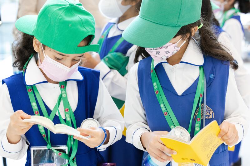 Schoolchildren compare stamps in their Expo passports. Photo: Expo 2020 Dubai