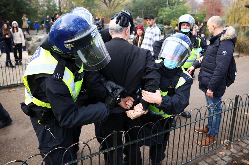 Police officers detain an anti-lockdown protestor during a demonstration amid the coronavirus disease (COVID-19) outbreak in London.  Reuters