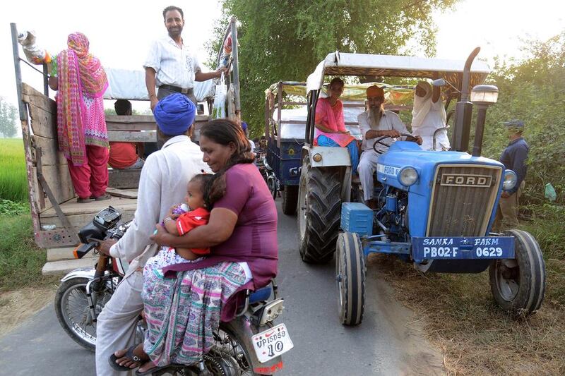 Indians ride on a tractor as they evacuate a village near Dauke, about 40 kilometres from Amritsar on September 29, 2016. The Punjab state government ordered an evacuation within a 10km radius from the India-Pakistan border. Indian commandos carried out strikes Friday along the border with Pakistan in Kashmir, provoking charges of “naked aggression” from its nuclear-armed neighbour. Narinder Nanu / Agence France-Presse