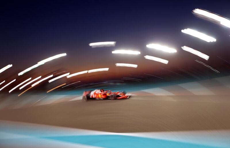 Ferrari's Sebastian Vettel drives under lights.  EPA