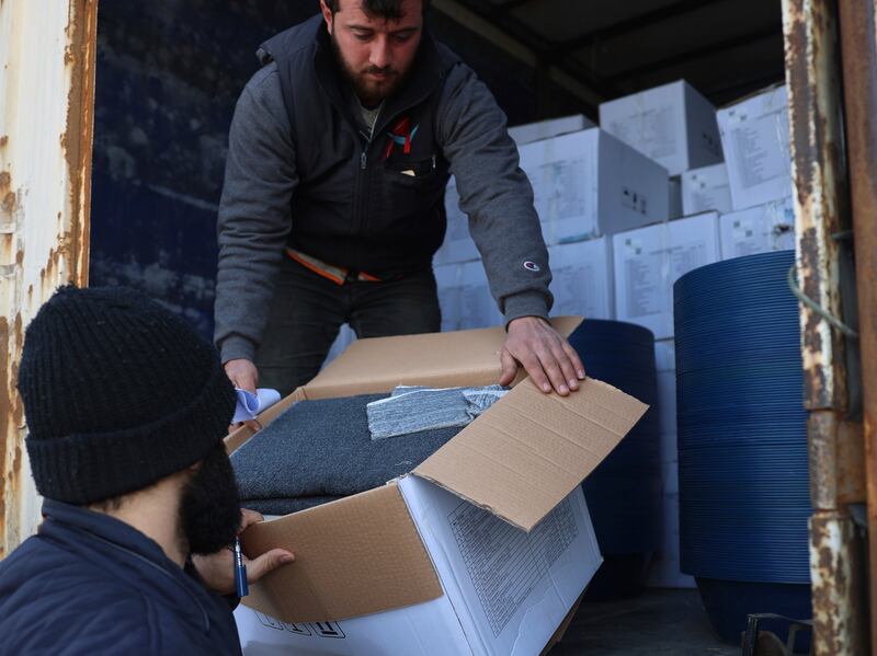Border customs officials inspect a lorry loaded with UN humanitarian aid for Syria at the Bab Al Hawa border crossing with Turkey. AP