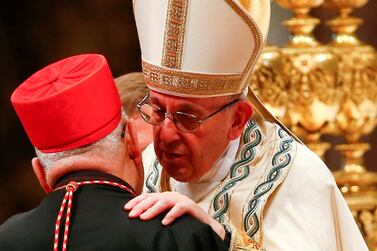 Pope Francis embraces new cardinal Louis Raphael I Sako of Iraq during a consistory ceremony to install 14 new cardinals in Saint Peter's Basilica at the Vatican in 2018. Reuters