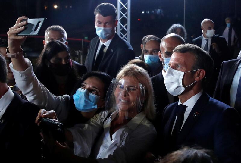 The French president poses for selfies after a news conference at the Pine Residence in Beirut on September 1, 2020.  AFP
