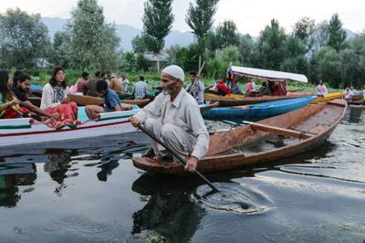 A vendor rows his Shikara at the floating vegetable market on Dal Lake in Srinagar. Local businesses, entrepreneurs and traders are struggling due to back-to-back lockdowns. Getty Images