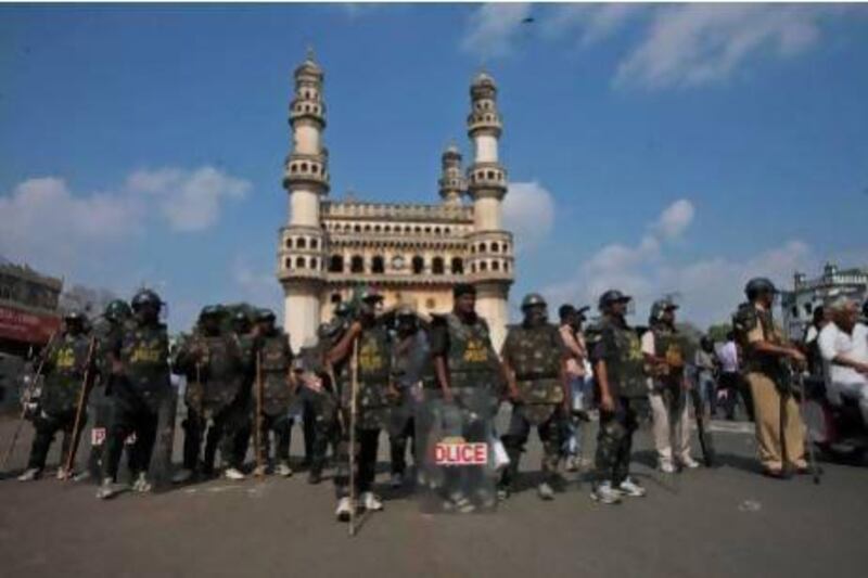 Indian police stand guard in front of the landmark Charminar monument during Friday prayers in Hyderabad.