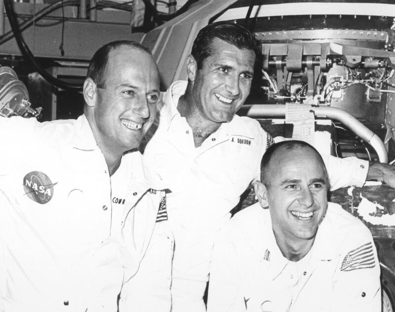 Alan Bean, right, is seen with Pete Conrad, and Dick Gordon while posing for photos during a visit to North American Rockwell Space Division, Downey, California. EPA