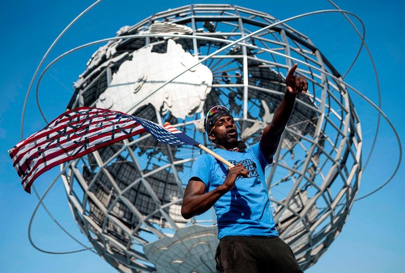 A protestor holds an upside-down American flag in front of the Unisphere during a Justice Ride, supporting the Black Lives Matter movement in the Flushing Meadows-Corona Park in the borough of Queens, New York City, US. AFP