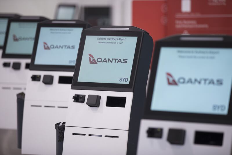 Qantas Airways' self check-in machines at Sydney Airport in Australia. The airline reported bumper profits on August 24. Bloomberg