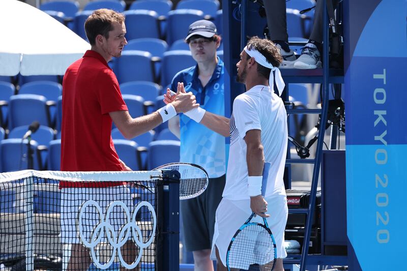 Russia's Daniil Medvedev (L) shakes hands with Italy's Fabio Fognini.