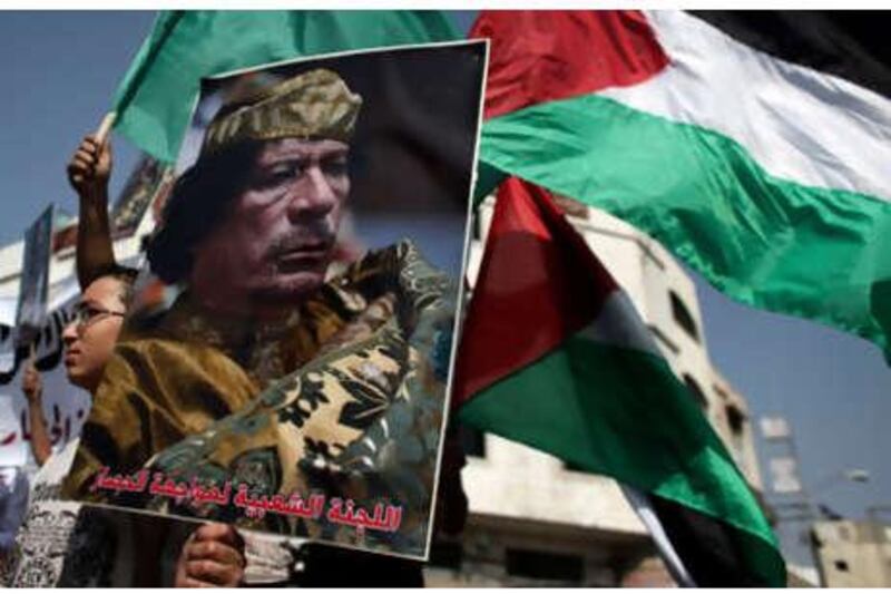 A Palestinian boy holds a poster of Libyan leader Muammar Ghadafi, during a rally to support a Libyan ship making its way towards Gaza in the latest attempt to thwart an Israeli naval blockade, in Gaza City, on Monday.