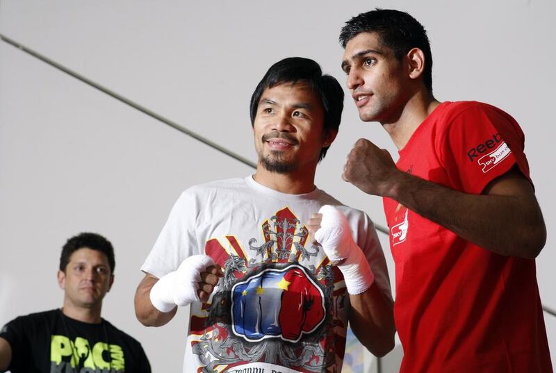 Manny Pacquiao, left, and Amir Khan, right, are edging closer to a fight, expected to take place in the UAE. Steve Marcus / Reuters