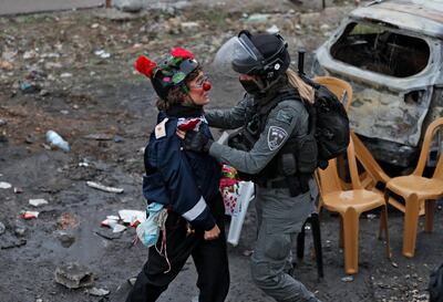 Az-Oolay and an Israeli police officer during a demonstration in Sheikh Jarrah, occupied East Jerusalem, on December 17. AFP