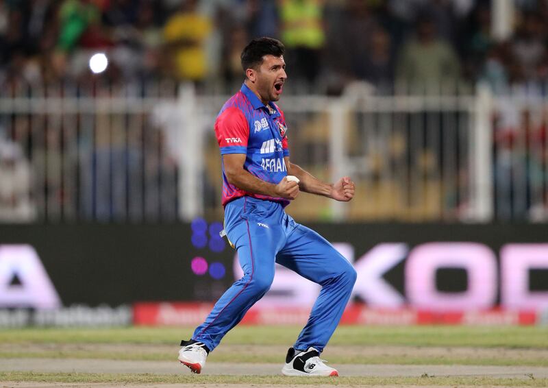 Afghanistan's Fazalhaq Farooqi celebrates taking the wicket of Pakistan captain Babar Azam for a duck.