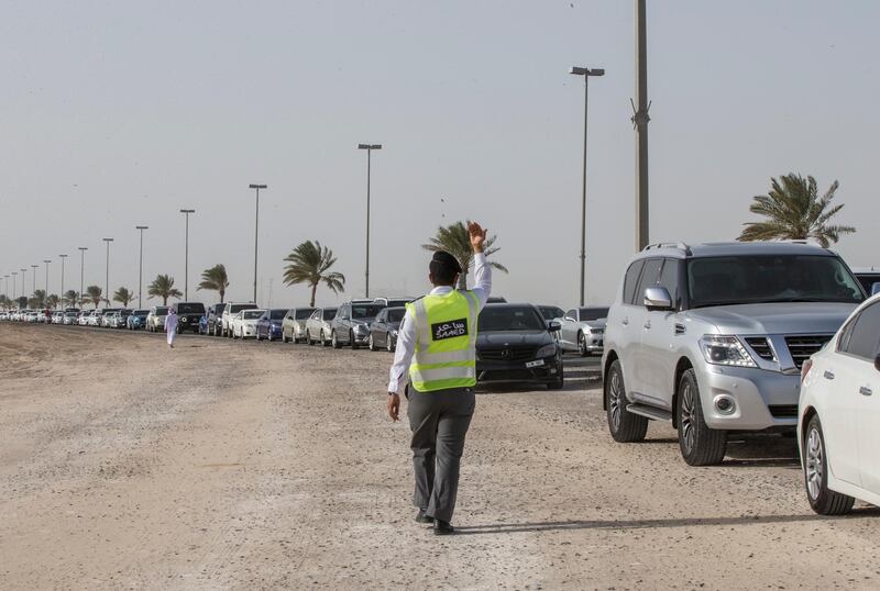 Dubai, United Arab Emirates - An officer controlling the queue to avoid traffic at the new  DPI Testing Centres border of Dubai and Abu Dhabi.  Leslie Pableo for The National for Shireena Al Nowais story